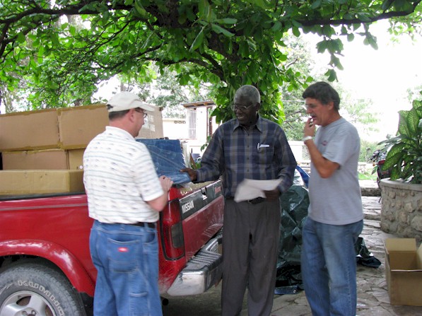 Pastor Gordon, Pastor Preval, Ray Konn with tents for Haiti.