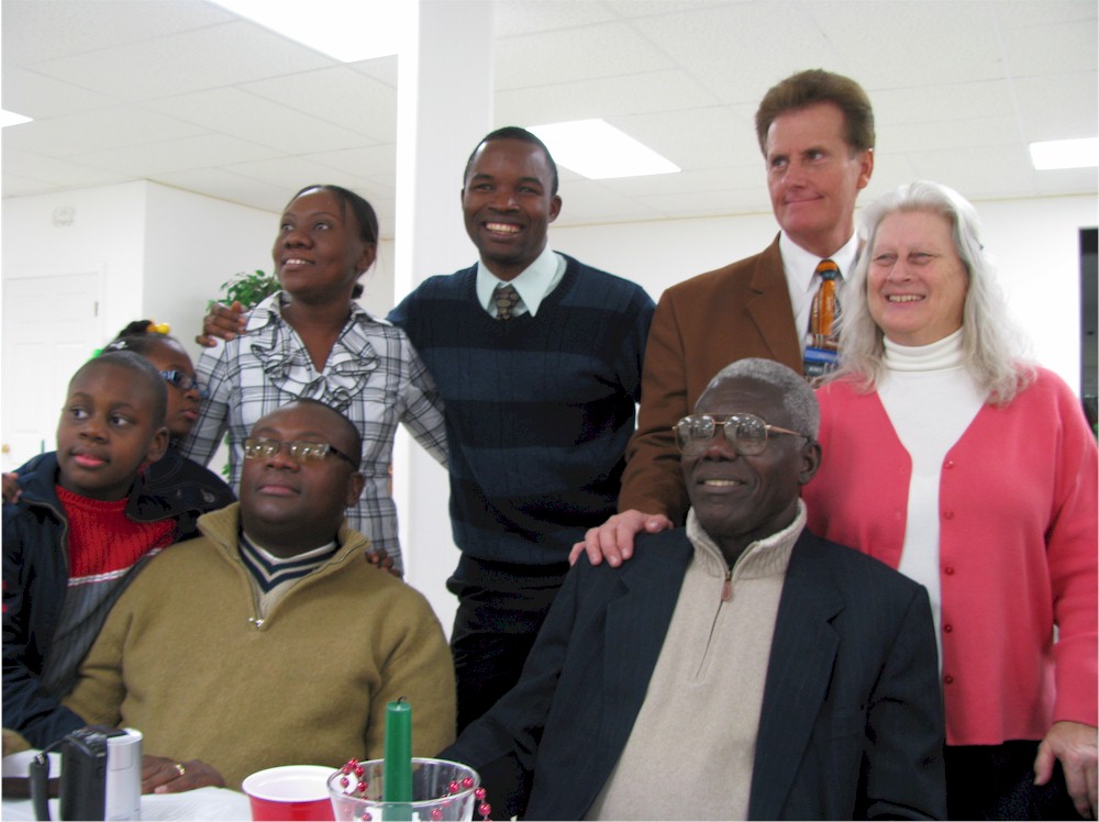 Pastor Preval Meritil surrounded by Haitians and Pastor Bill Fitchett